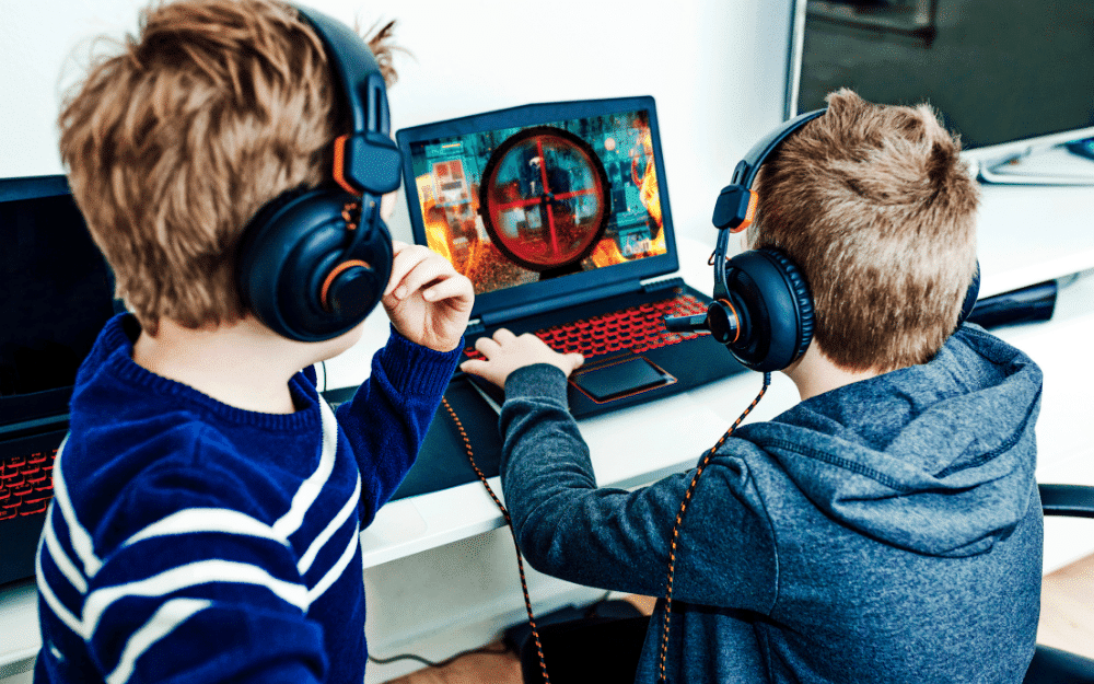 an illustration of two kids know How to download games on a Lenovo laptop